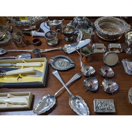 376 - A mixed lot of silver plate to include a pair of Sheffield plated candlesticks, wine coaster and bot... 