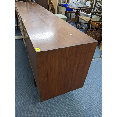 380 - A mid 20th century McIntosh teak sideboard having four drawers flanked by cupboard doors, 76.5cm h x... 