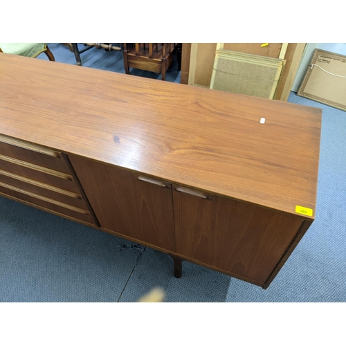 380 - A mid 20th century McIntosh teak sideboard having four drawers flanked by cupboard doors, 76.5cm h x... 