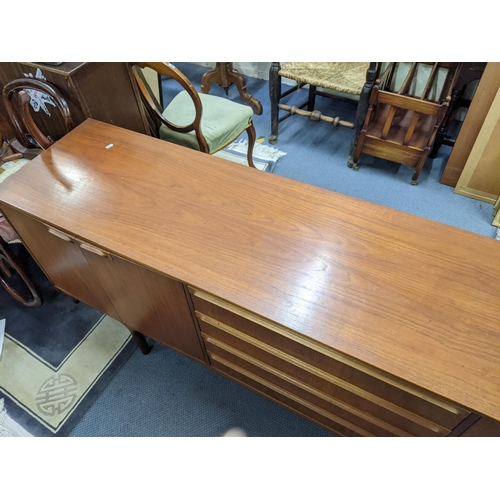 380 - A mid 20th century McIntosh teak sideboard having four drawers flanked by cupboard doors, 76.5cm h x... 