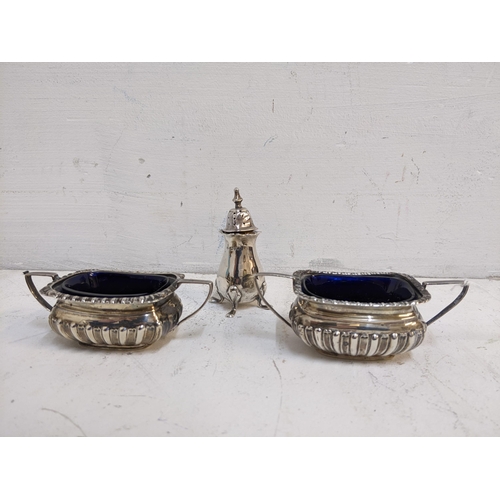 381 - A pair of Edward VII silver salt pots with fluted edge rim and base, blue glass liners, Birmingham 1... 