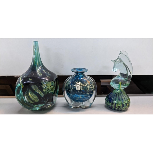 436 - Nine pieces of Mdina glass to include a blue and green vase with a swirling design and a flared rim ... 