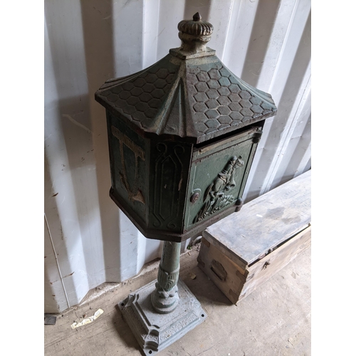 471 - A late Victorian cast iron green painted letter box, the door relief decorated with a figure on hors... 