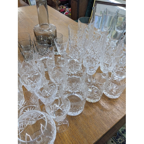 498 - Glassware to include Caithness smoked glass decanter, along with port, wine, brandy glasses and othe... 