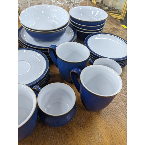 501 - A Denby blue part dinner service to include dinner and side plates, desert bowls, a milk jug, sugar ... 