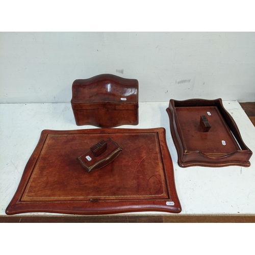 540 - A mid century faded leather desk set comprising writing panel with lift up top, stationery box with ... 