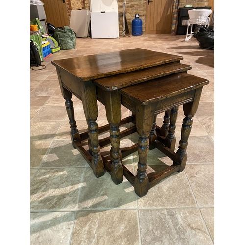 543 - A reproduction oak coffee table, together with a matching magazine rack and nest of three tables Loc... 