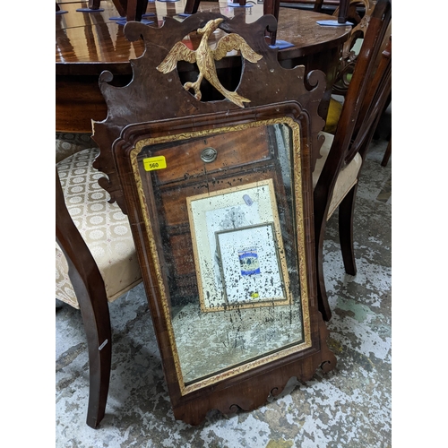 560 - A Georgian walnut fretwork wall mirror in the Chippendale style with gilt phoenix bird decoration, r... 