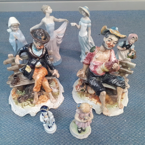 561 - A group of late 20th century china figures to include Lladro and Capodimonte to include one signed T... 