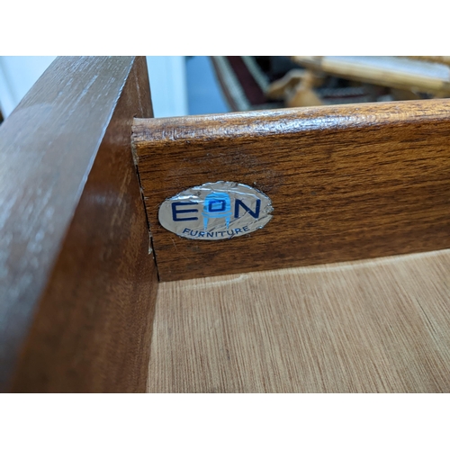 85 - An Elliots of Newbury bow fronted teak sideboard with three drawers over three cupboards on tapered ... 