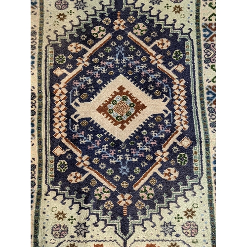 68 - A handwoven Turkish Kazak design rug with a central symmetrical gull with repeating motifs around th... 