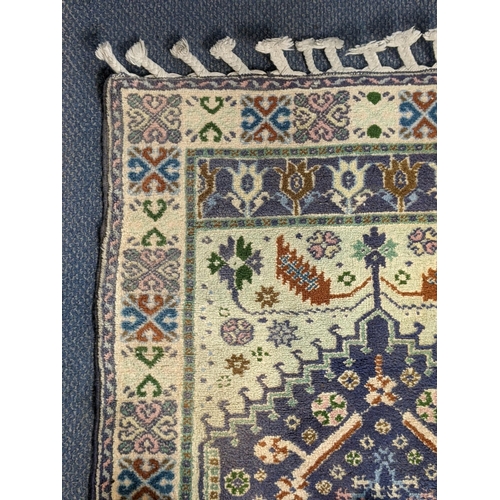 68 - A handwoven Turkish Kazak design rug with a central symmetrical gull with repeating motifs around th... 