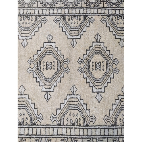 71 - A handwoven Persian design silk rug, the geometric design with four motifs on a cream background 98c... 