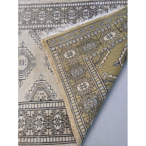 71 - A handwoven Persian design silk rug, the geometric design with four motifs on a cream background 98c... 