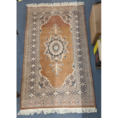 72 - A handwoven Turkish design Oushak rug with a central symmetrical motif and a repeating border on a l... 