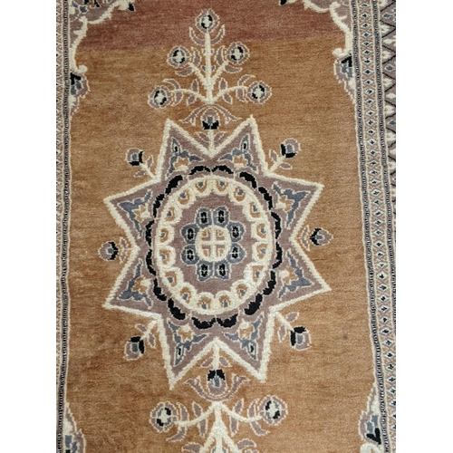 72 - A handwoven Turkish design Oushak rug with a central symmetrical motif and a repeating border on a l... 