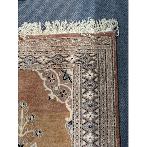 72 - A handwoven Turkish design Oushak rug with a central symmetrical motif and a repeating border on a l... 