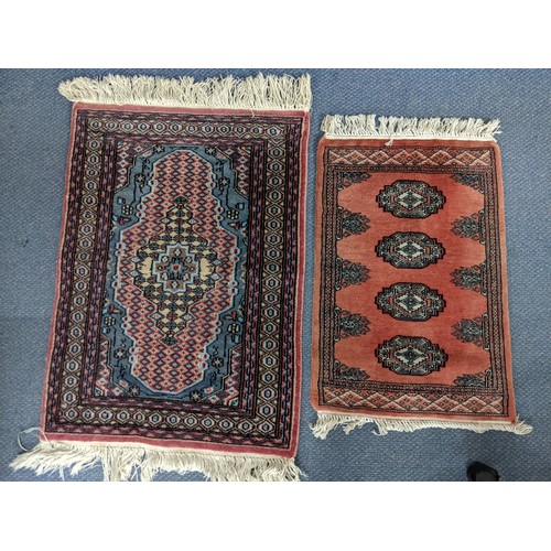 69 - Two small handwoven rugs of Persian design, one with four repeating gulls and one with a central med... 