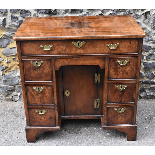 123 - An early George III burr walnut and feather-banded kneehole desk, the bookmatched veneer top with he... 