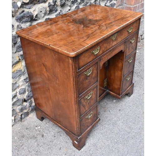 123 - An early George III burr walnut and feather-banded kneehole desk, the bookmatched veneer top with he... 