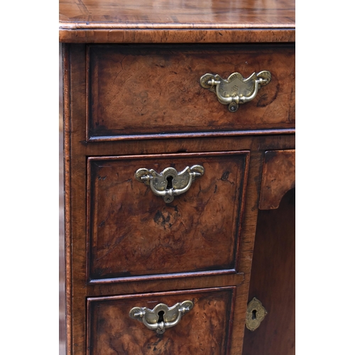 123 - An early George III burr walnut and feather-banded kneehole desk, the bookmatched veneer top with he... 