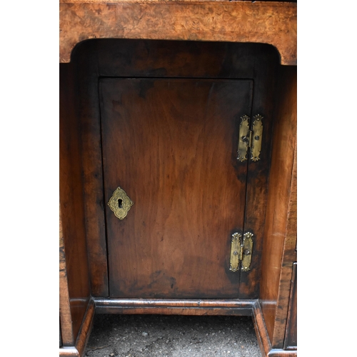 123 - An early George III burr walnut and feather-banded kneehole desk, the bookmatched veneer top with he... 