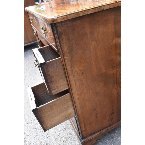 123 - An early George III burr walnut and feather-banded kneehole desk, the bookmatched veneer top with he... 