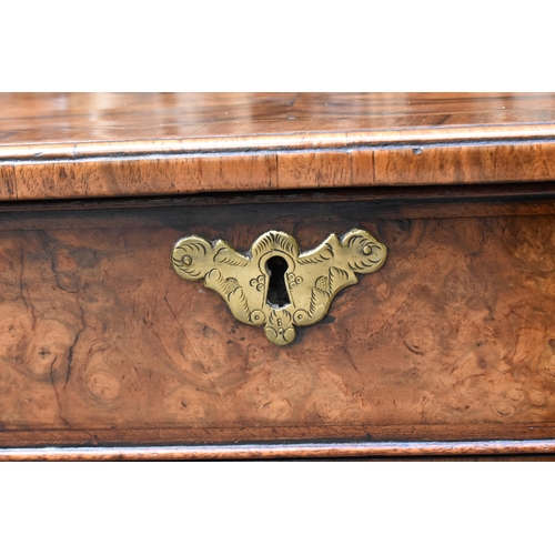 123 - An early George III burr walnut and feather-banded kneehole desk, the bookmatched veneer top with he... 