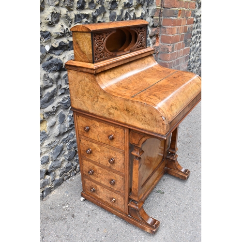 124 - A Victorian burr walnut piano Davenport, circa 1870, the pop-up top with fret-work letter compartmen... 