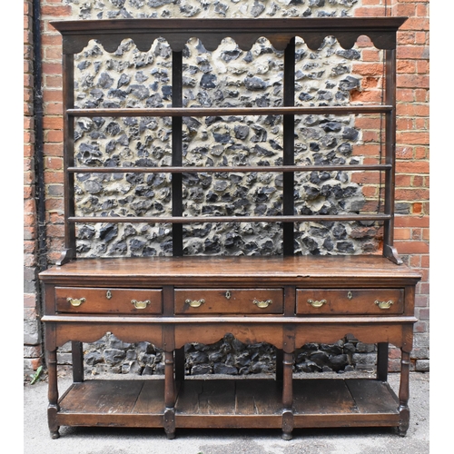 125 - A George III oak open potboard dresser, in two sections, designed with moulded cornice above three s... 