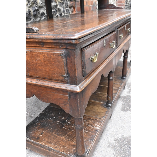 125 - A George III oak open potboard dresser, in two sections, designed with moulded cornice above three s... 