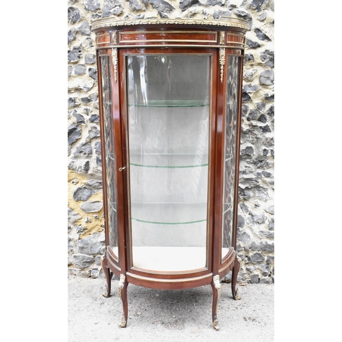 127 - A French Louis XVI style vitrine, 20th century, of D-shape, the top with pierced gallery and marble ... 