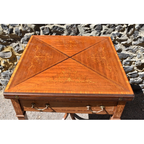 129 - An Edwardian satinwood envelope card table by Maple & Co, the square top with each flap string inlai... 