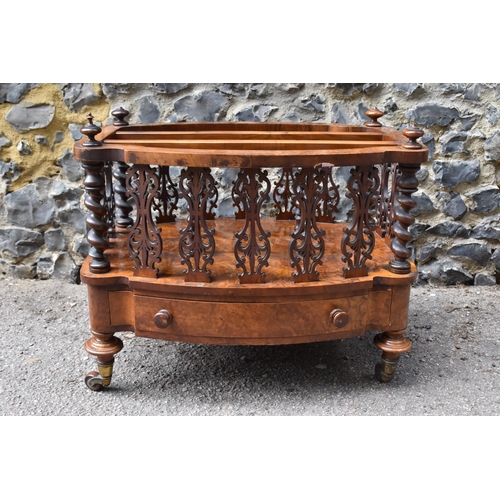 132 - A Victorian figured walnut two division music canterbury, of oval outline, with a spindle and fret g... 