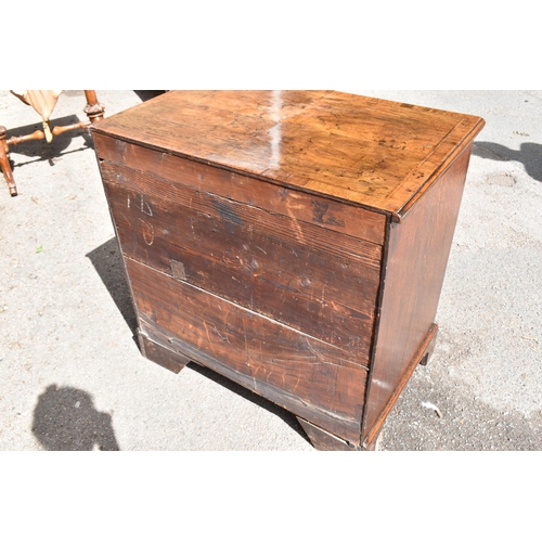 135 - An early George III walnut and feather-banded kneehole desk, the bookmatched veneer top with herring... 