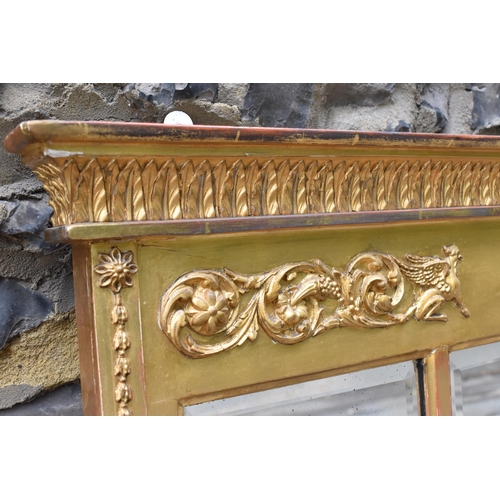 146 - A Regency style gilt overmantle mirror, designed with moulded leaf tip and acanthus scrolls with sat... 