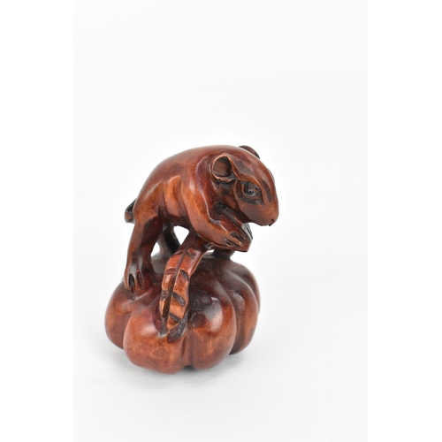 46 - Three Japanese carved wooden netsukes, 20th century, comprising a model of a hare, a mouse, and a wa... 