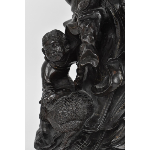 50 - A Chinese hardwood and brass inlaid sculpture of the immortal Shou Xing, late 19th century, the elde... 