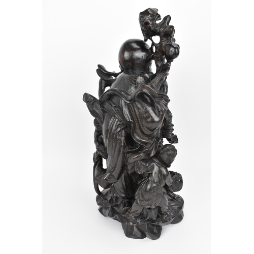 50 - A Chinese hardwood and brass inlaid sculpture of the immortal Shou Xing, late 19th century, the elde... 