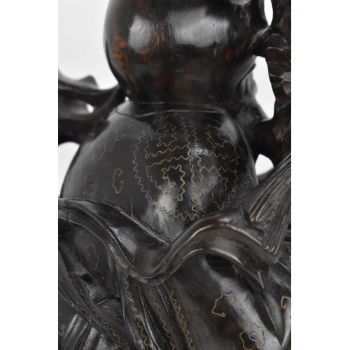 50 - A Chinese hardwood and brass inlaid sculpture of the immortal Shou Xing, late 19th century, the elde... 