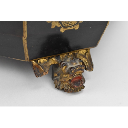 71 - A 19th century Chinese black lacquered tea caddy, of sarcophagus form, with gilt chinoiserie decorat... 