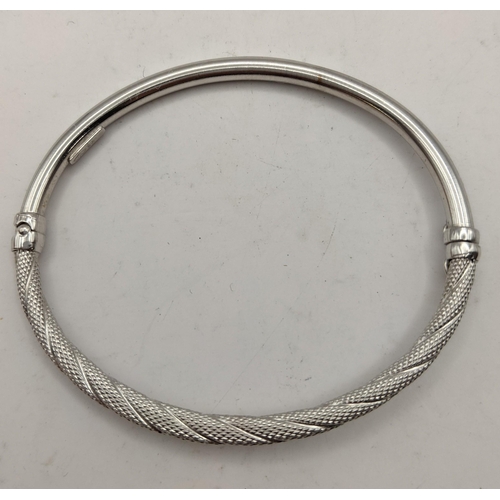 An 18ct gold half rope twist bracelet having a safety catch clasp 3.5g, 5.5cm dia
Location:CAB 7