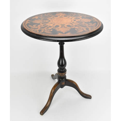 142 - A Victorian walnut and marquetry tilt top wine table, the circular top with inlaid c-scrolls and fol... 