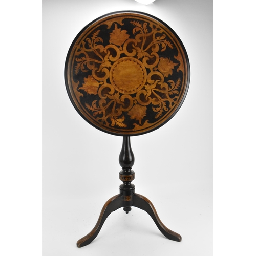 142 - A Victorian walnut and marquetry tilt top wine table, the circular top with inlaid c-scrolls and fol... 