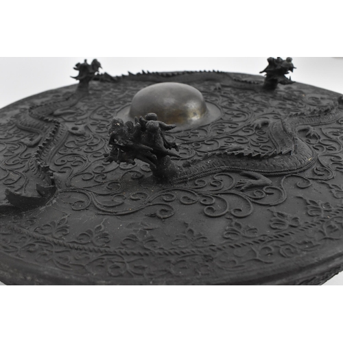 33 - A 19th century Chinese gong, with raised decoration of three dragons and scrolls, with central domed... 