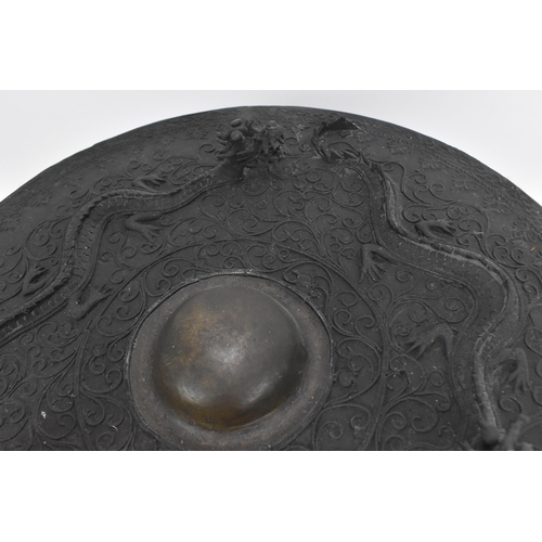 33 - A 19th century Chinese gong, with raised decoration of three dragons and scrolls, with central domed... 