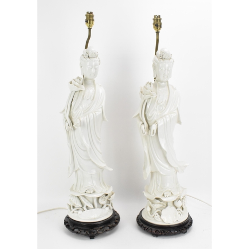 67 - Two large Chinese Dehua figures of Guanyin, Republic period, with draped clothing, holding a lotus f... 