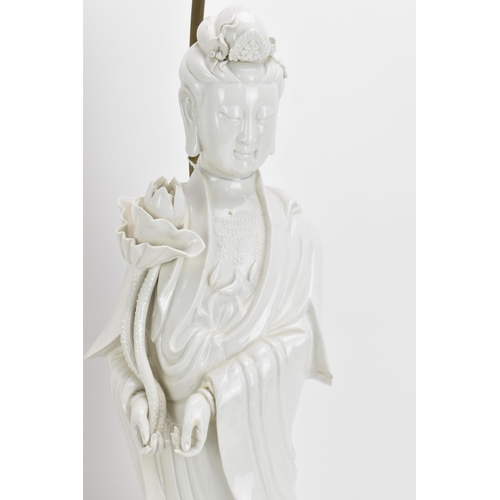 67 - Two large Chinese Dehua figures of Guanyin, Republic period, with draped clothing, holding a lotus f... 