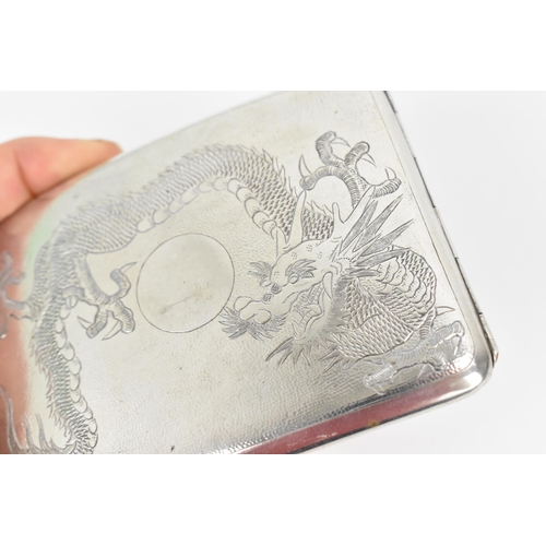 74 - A Chinese export white metal cigarette card case, early 20th century, designed with dragons chasing ... 