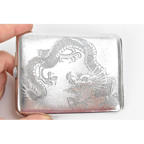 74 - A Chinese export white metal cigarette card case, early 20th century, designed with dragons chasing ... 